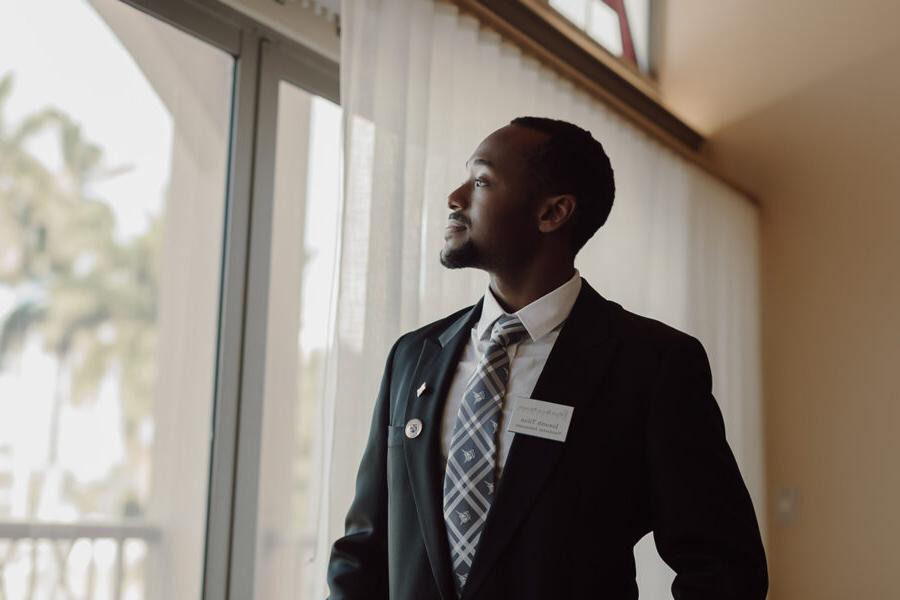 Business student looks out of window at Palm Beach Atlantic University